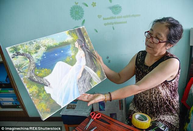 Zhang's mother shows off one of her daughter's masterpiece in Taiyuan city, Shanxi province